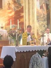 Bishop Edward Whalen (left) joined with the pastor of St. Brigid parish, Father Sean Connolly, to celebrate Mass at the historic East Village Church which was marking the 175th anniversary of the laying of the church’s cornerstone in 1848. Photo: Keith J. Kelly