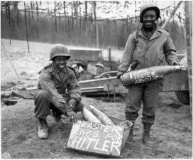 Black Army soldiers T/5 William E. Thomas and Pfc. Joseph Jackson show off their “Easter Eggs for Hitler,” Easter morning, March 10, 1945.