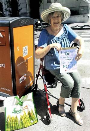 Elizabeth K. Rogers made a sign asking for help when she was not able to work the app needed to open a compost bin near her apartment.