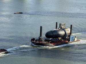 The vessel seen floating on a barge headed north up the East River onAug. 20 is described as a Trident nuclear-powered attack submarine by warship experts.