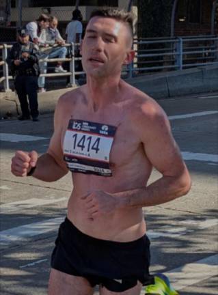 Bib 1414 appeared to pin his number directly to his chest. Identified as Connor Strynkowski, of New York Harriers, he finished in a very impressive 2:38:16.