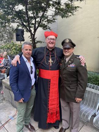 Cardinal Timothy Donal (center) greets four star U.S. Army General Austin Scott Miller, former commander of NATO forces in Afghanistan, and US Army Colonel Nick Lorusso prior to start of ceremony commerating 15 firefighters from a single house lost on 9-11.