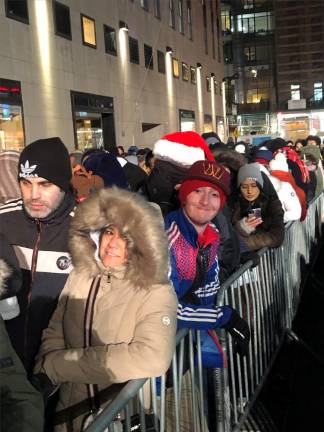 <b>People who turned out to watch the tree lighting in Rockefeller Center on Fifth Ave. were told to “keep moving” due to security concerns although it did not seem to dampen spirits</b>. Photo: Keith J. Kelly