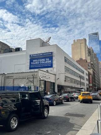 320 W. 31st St, which still bears a sign attesting to its previous use by Touro College, has been shut down as a migrant shelter for single men after the FDNY issued a vacate order.