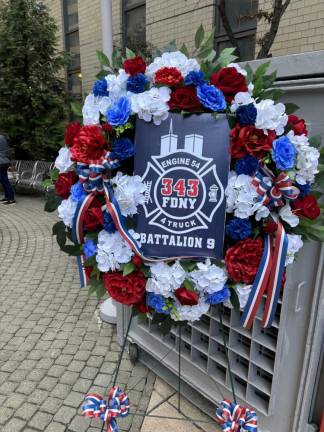 A wreath commerates the 343 firefighters who died on line, which includes the 15 from Battalion 9, Engine 54, Truck 4 firehouse, the most casualties suffered by any single firehouse on 9-11.