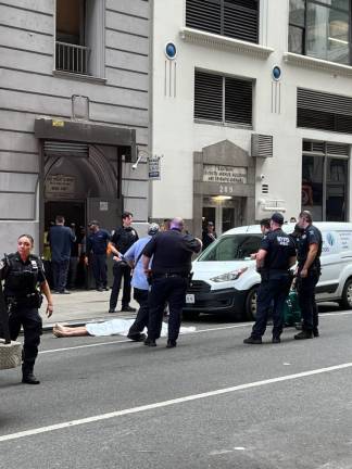 The scene of a reported suicide on W. 35th St., with police redirecting passersby on July 18 as the body of the victim lies in the street.