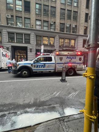 A police vehicle next to the scene where a man is believed to have leaped to his death from a building on W. 35th St.