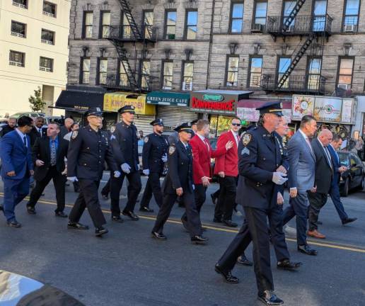 Cops and police fraternal reps marching. Sgt. Johnny Moynihan in one white glove at right.