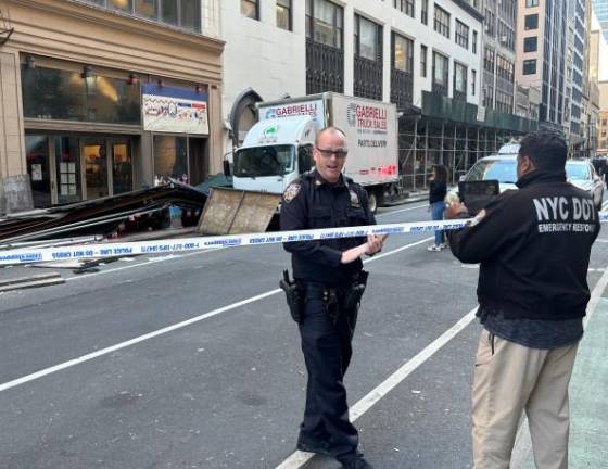 Police shut down W. 29th St. between Seventh and Eighth Ave. on Nov. 18 after an early morning collision with scaffolding by a box truck injured three people, one critically.