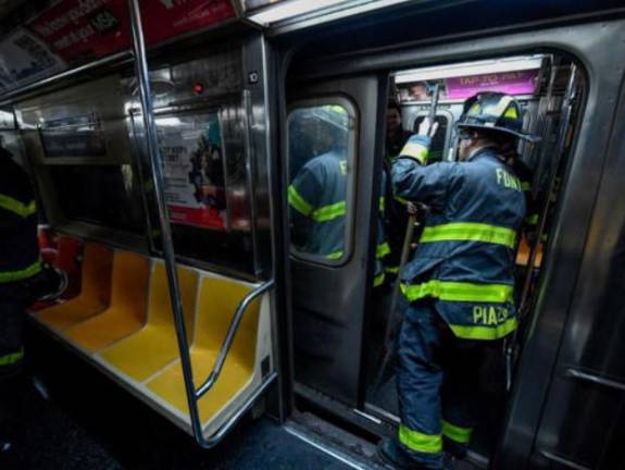 Firefighters has to pry open doors to the derailed #1 train at the 96th Station on Jan. 4, allowing 300 passengers to safely evacuate. Photo: Marc A Herman/MTA