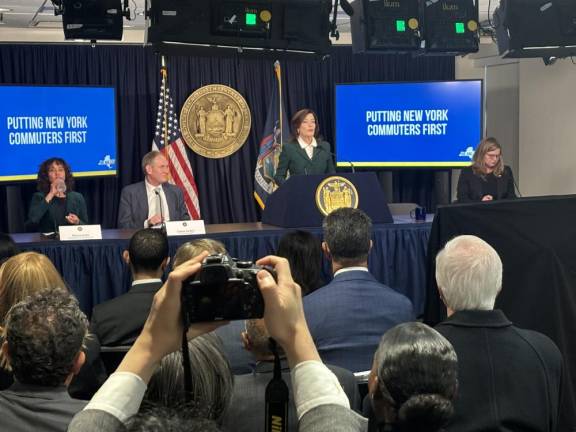 On the dias with Governor Kathy Hochul (standing) in which she revealed the new congestion pricing toll of $9 for cars during peak hours were (from l to r) NYC deputy mayor Meera Joshi, MTA chairman Janno Leiber and Houchul’s director of operations, Kathryn Garcia.