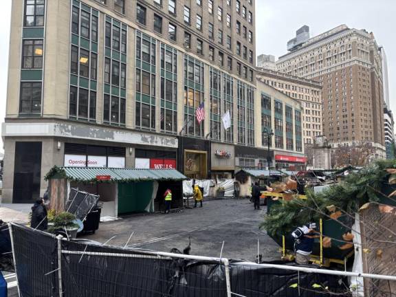 Clean-up was underway at the Herald Holiday Market north of 35th St. at Broadway on Dec. 17, following the early morning fire on Dec. 16 that decimated the northern portion of the market. The southern portion of the outdoor market in front of Macy’s was spared.