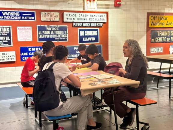 On a hot July weekend afternoon, a group of teenagers participate in the joint Whitney/Transit Museum art creation project; as they made art, signs from many different eras highlight their workspace.