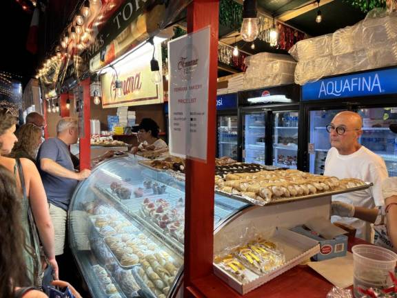 Lifelong Little Italy resident Pelligrino Russo was doing a brisk business at the stand for his Ferrara Bakery.