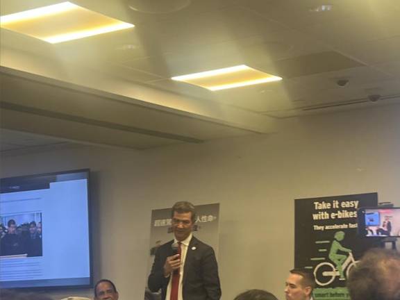 NYC DOT Commissioner Ydannis Rodriguez speaking at a Jan. 15 media roundtable, where he touted a new “microhubs” pilot program and discussed the ongoing “Get Smart Before You Start” e-bike safety campaign (pictured on poster, back-right).