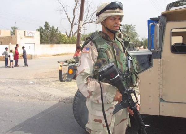 Aqulino Gonell getting ready to escort a convey in Iraq.