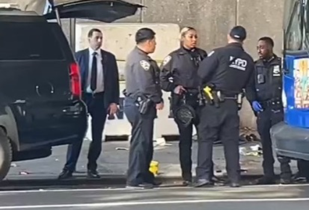 Police officers at the scene of one of three fatal stabbings, reportedly committed by one suspect, on Nov. 18. Ramon Rivera, 51, has been taken into custody in connection with the attacks and charged with three counts of first degree murder.