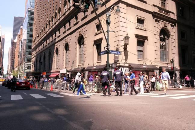 Asylum-seekers queuing up in Midtown Manhattan in July 2023 following the conversion of the Roosevelt Hotel into a shelter and intake center. On Dec. 10, Mayor Eric Adams announced that six migrant shelters in Manhattan would be closing in the next two months as part of a plan to close 25 across the city, although the Roosevelt Hotel is not one of them.