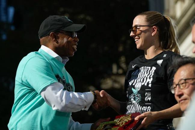 NYC Mayor Eric Adams giving New York Liberty player–and WNBA champion–Ivana Dojkić a Key to the City of New York.