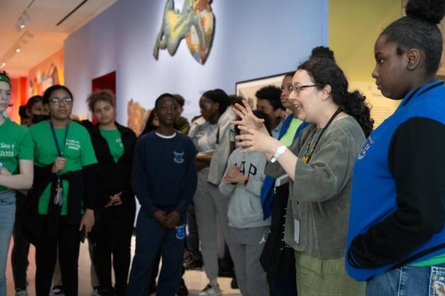 A Museum instructor educating students about an exhibit at the Museum of the City of New York