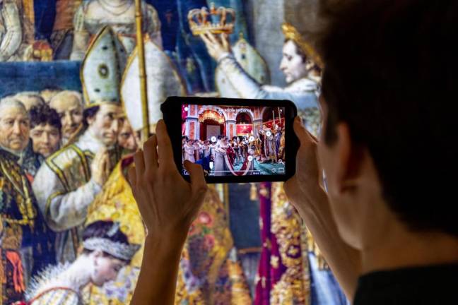 Photo of a previous Notre-Dame Augmented Experience exhibit, featuring Histovery’s “HistoPad” AR tablets. The photo features a painting of Napoleon’s coronation, which co-founder Lussan said turned out to be highly inaccurate as they attempted to virtually reconstruct the scene.