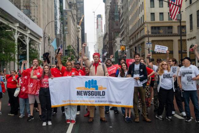 NewsGuild members raise their fists