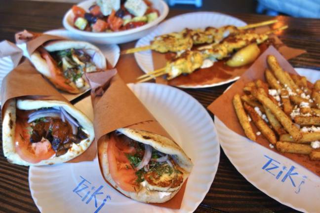 All the dishes offered at Tziki Souvlaki, the newest restaurant to open in Chelsea, were inspired by family recipes that the owners imported from Greece. The dishes shown are (counterclock wise from the top)