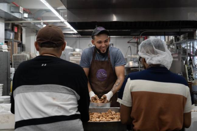 The three chocolatiers work together on making the buttercrunch candies.