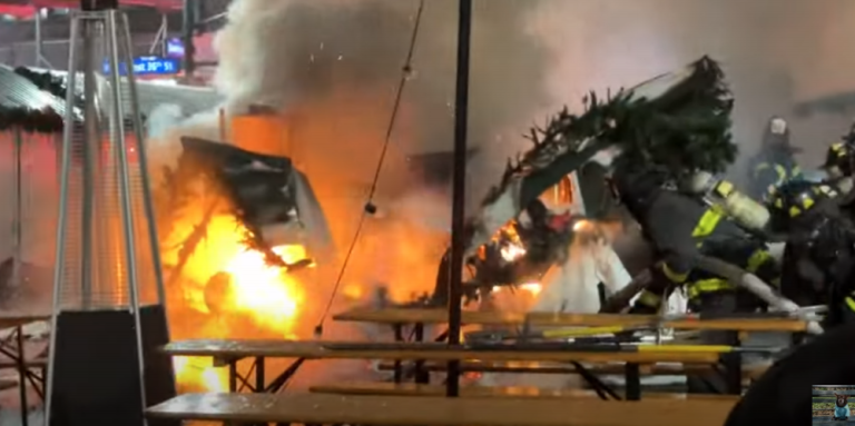 Another angle of a stall being torched at the Herald Square Holiday Market on the morning of Dec. 16, with firefighters (right) battling the blaze.