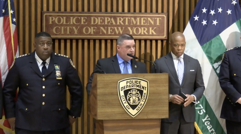 NYPD officer James Essig at press conference with Mayor Eric Adams, right, and Chief of Department Jeffrey Madrey, announcing the arrest of the hazmat killer who murdered a deli worker on the Upper East Side and robbed two other delis and a bagel store. Photo: NYPD.