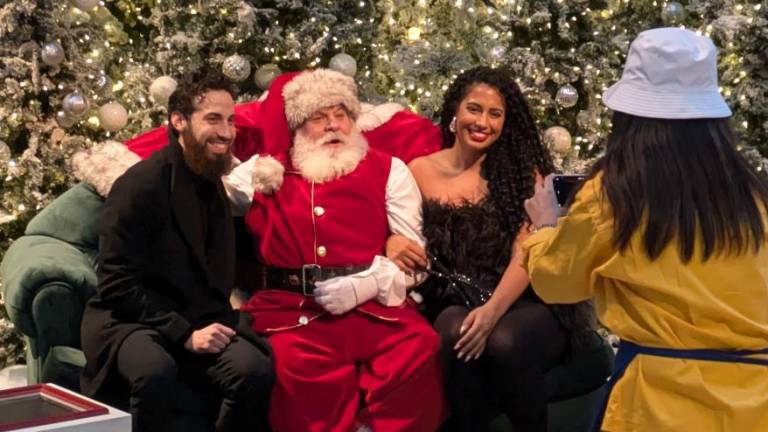 The young at heart are drawn to Santa for a photo at Brookfield Place, Dec. 15, 2024.